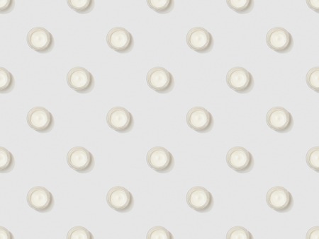 cosmetic cream in containers on grey background, seamless background pattern