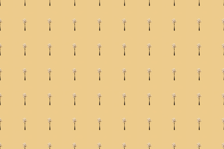 scattered flour in spoons on yellow background, seamless patternの写真素材