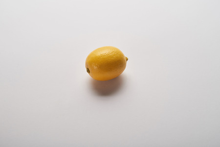 yellow ripe whole lemon on grey backgroundの写真素材