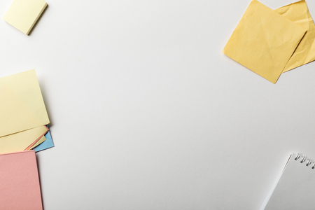 top view of notebook near sticky notes on white backgroundの写真素材