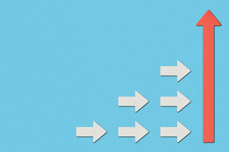 top view of white arrows directed to big red pointer on blue backgroundの写真素材