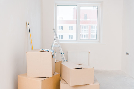 room with carton boxes and metallic ladder