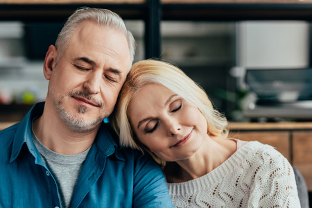 happy husband and wife sleeping at homeの写真素材