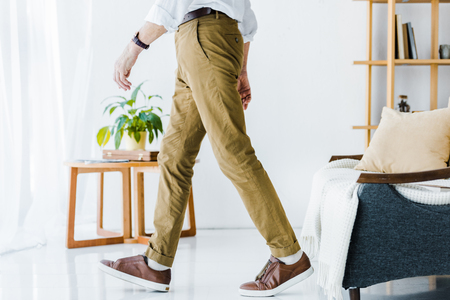 cropped view of senior man walking at modern homeの写真素材