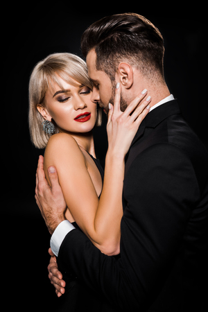 beautiful tender couple embracing isolated on blackの写真素材