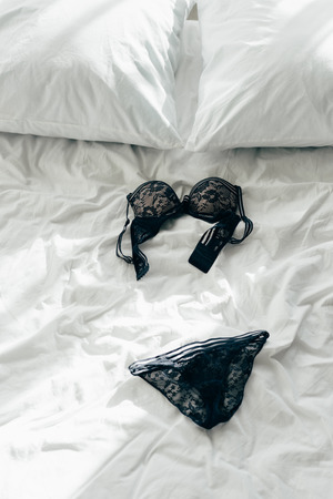 sexy black lace bra and panties on bedの写真素材