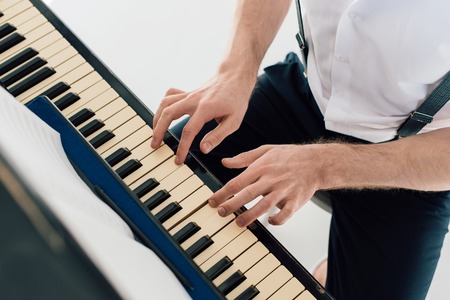 selective focus of pianist in white shirt playing pianoの写真素材