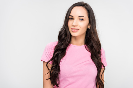 beautiful girl standing and smiling isolated on greyの写真素材