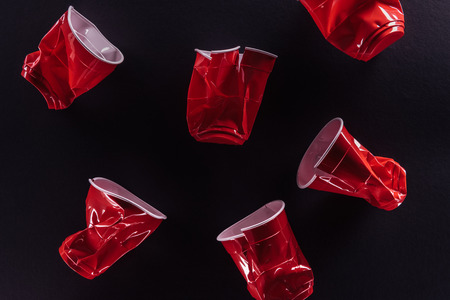 Red plastic cups isolated on a black backgroundの写真素材