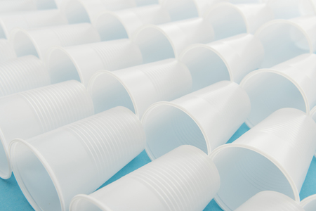 selective focus of white and plastic cups with copy space