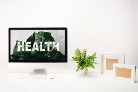 computer with health lettering on monitor on white background