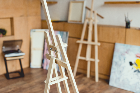 selective focus of wooden easel in painting studioの写真素材