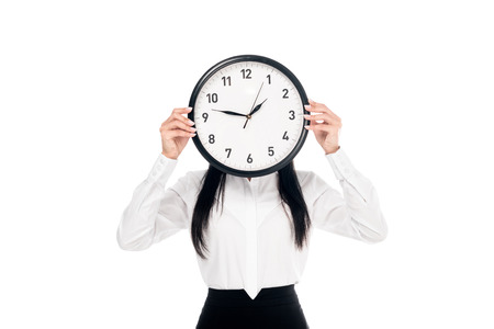 Brunette businesswoman in shirt holding clock isolated on whiteの写真素材