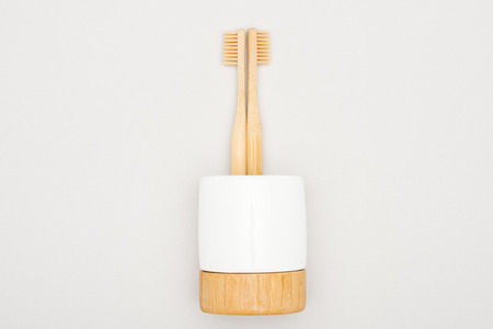bamboo toothbrushes in stand on grey backgroundの写真素材