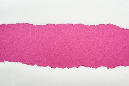 ripped white textured paper with copy space on crimson backgroundの写真素材