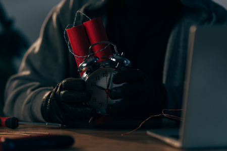 Partial view of criminal in leather gloves holding bombの写真素材