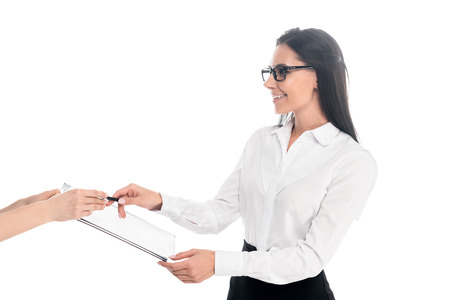 Charming businesswoman in glasses signing contract isolated on whiteの写真素材