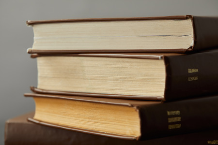 Old brown books with yellow pages isolated on greyの写真素材