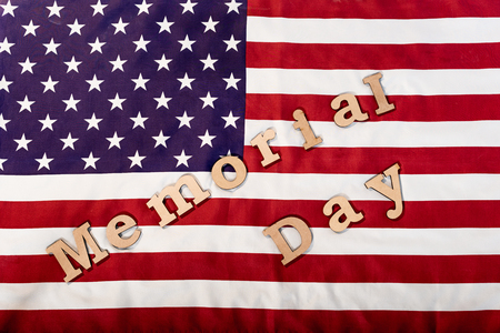 top view of memorial day lettering on american flag with stars and stripesの写真素材