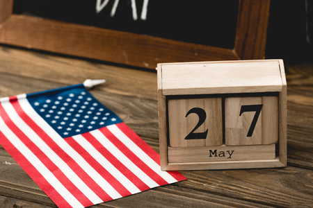 wooden cubes with date near flag of america with stars and stripesの写真素材