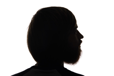 Silhouette of man with beard looking away isolated on whiteの写真素材