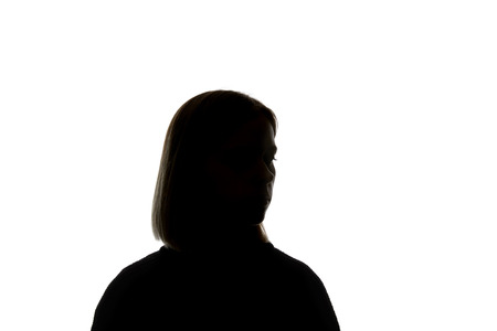 Silhouette of woman looking away isolated on whiteの写真素材