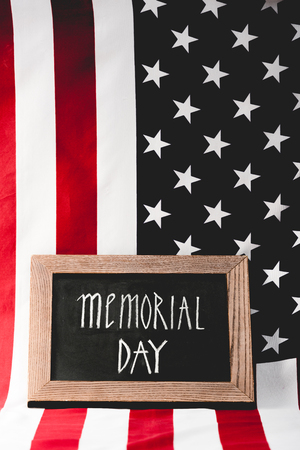flag of memorial day lettering on chalkboard near america with stars and stripesの写真素材