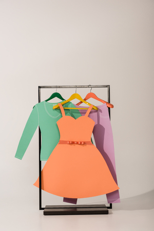 rack with colorful paper clothes on whiteの写真素材