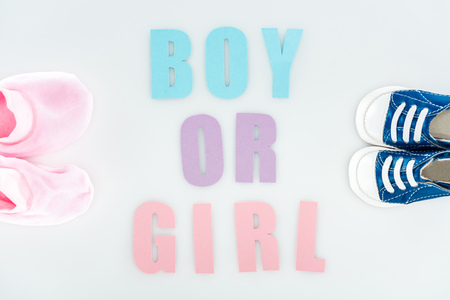top view of booties and sneakers, boy or girl lettering isolated on whiteの写真素材