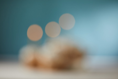 blurred turquoise background with bokeh lights and copy space