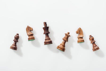 top view of wooden brown chess figures on white backgroundの写真素材