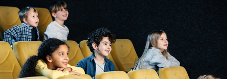 panoramic shot of multicultural friends spending time in cinema together