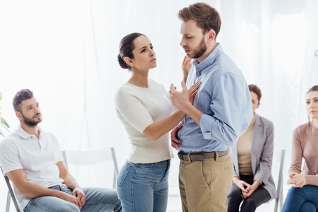 selective focus of woman consoling man during group therapy sessionの写真素材
