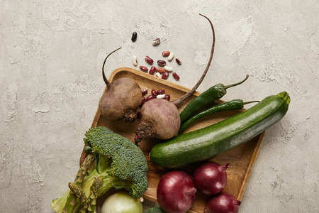 Top view of vegetables and beans on wooden trayの写真素材