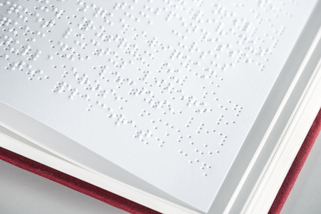 close up view of book with braille text isolated on greyの写真素材