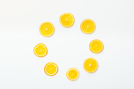 Flat lay with juicy cut fruits on white surfaceの写真素材