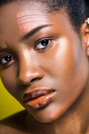 Sad african american young woman looking at camera on yellowの写真素材