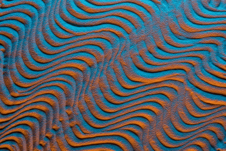 Top view of sandy background with color filter and abstract waves