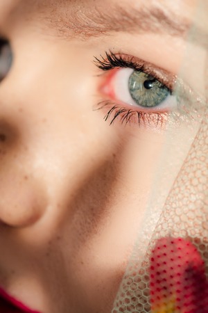 Close up view of young woman with golden eye shadowの写真素材