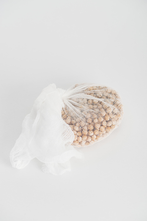 Chickpea in white cheesecloth on grey backgroundの写真素材
