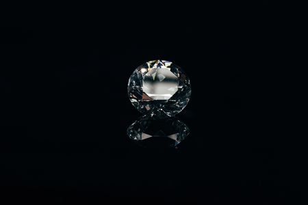 transparent pure sparkling diamond isolated on black with reflectionの写真素材