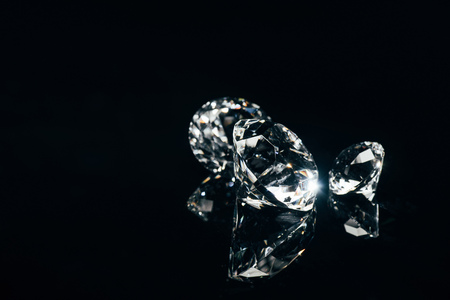 transparent pure diamonds isolated on black with reflectionの写真素材