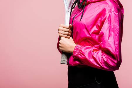 Cropped view of African American sportswoman holding tennis racket isolated on pink with copy spaceの写真素材