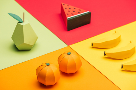 origami watermelon, pear, tangerines and bananas on colorful paperの写真素材