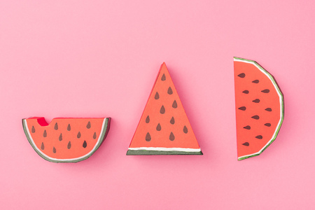 top view of handmade paper watermelon slices isolated on pinkの写真素材