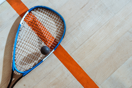 Top view of squash racket and ball on wooden surfaceの写真素材