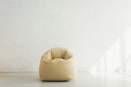 sunlight near bean bag chair near brick wall in modern homeの写真素材