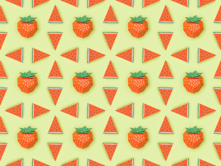 top view of pattern with handmade red paper strawberries and watermelon slices isolated on green