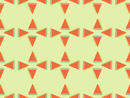 Top view of seamless pattern with handmade paper watermelon slices isolated on green backgroundの写真素材
