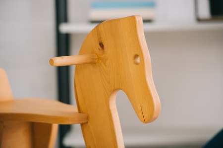 Selective focus of wooden rocking horse in living roomの写真素材